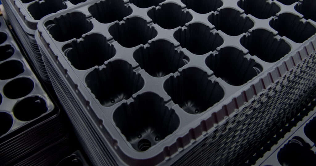 close-up black seed starting trays