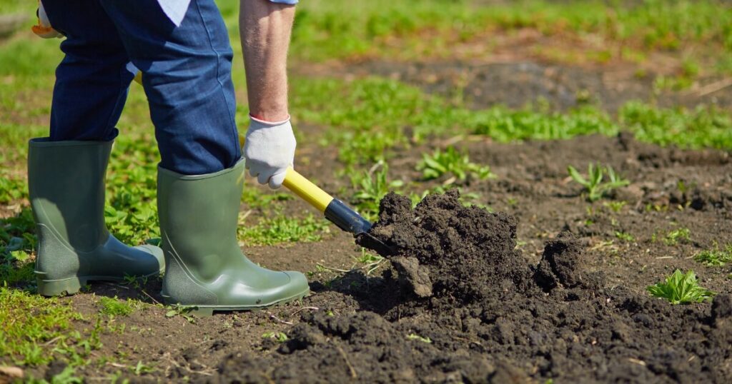 gardener digging soil with shovel